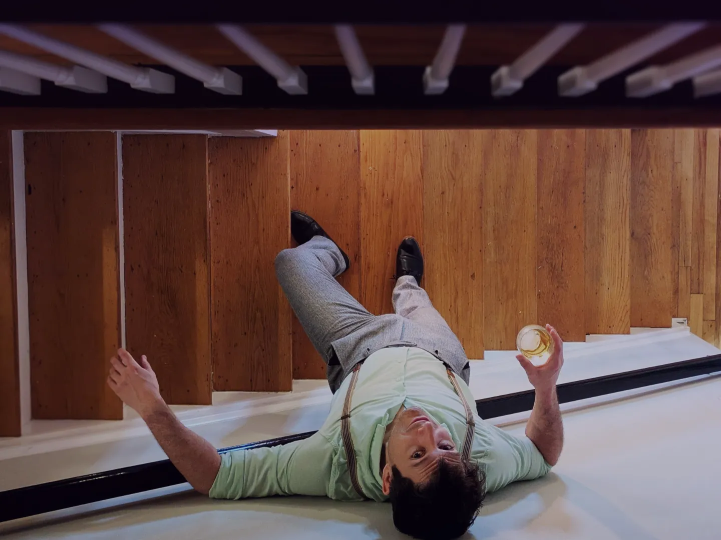 Man standing on a stairway, leaning against the wall as seen from overhead